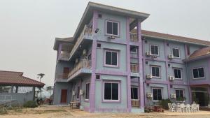 a large purple building with windows and balconies at khounxub view hotel in Ban Pho Touane