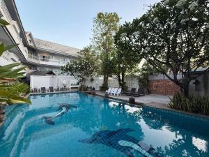 a swimming pool with a shark painted on it at Baan Suksiri Hotel Hua Hin in Hua Hin