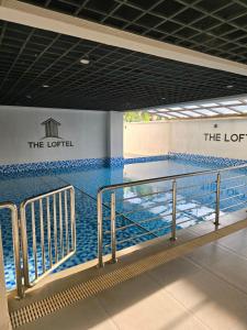 a swimming pool with the lortel logo on the wall at Serene Studio near UN headquarters and Gigiri in Ruaka