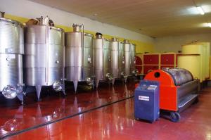 a room with a bunch of silver wine tanks at Cascina Bertolotto Wine Resort in Spigno Monferrato
