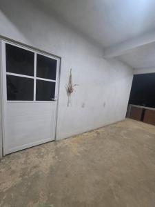 an empty garage with a door and a window at Estudio Mar in Brisas de Zicatela