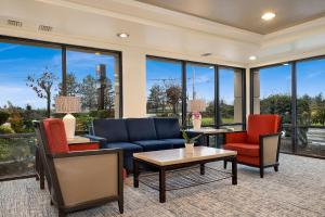 a living room with furniture and large windows at Comfort Inn Bellingham in Bellingham