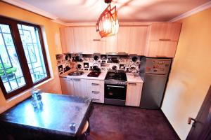 a kitchen with white cabinets and a stove top oven at Casa Camellia in Kobuleti +22 photos