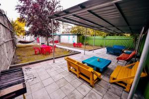 a patio with tables and chairs and a blue table at Casa Camellia in Kobuleti