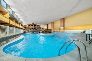 a large swimming pool in a hotel room at Suburban Studios, Kearney in Kearney