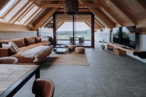 a large living room with a couch and a tv at Winzerhof - Deutsch Haseldorf in Deutsch Haseldorf +11 photos