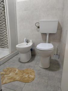 a bathroom with a toilet and a sink at Cascina Danila in Narzole +26 photos