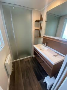 a bathroom with a sink and a mirror at Camping Mayotte, Biscarosse in Biscarrosse