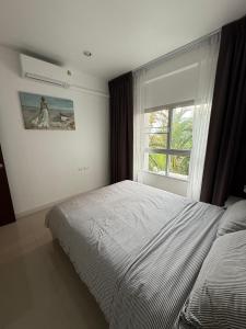 a bedroom with a bed and a window at Big Apartament with two bedrooms Karon in Phuket +8 photos