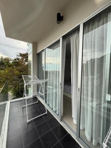 a balcony with a metal chair on a balcony at Big Apartament with two bedrooms Karon in Phuket