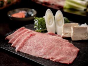 a plate of meat and other foods on a table at Sui Suwako in Suwa