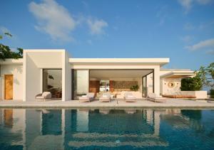 a house with a swimming pool in front of it at Cape Azure Resort Samui by Thalsea in Plai Laem +258 photos
