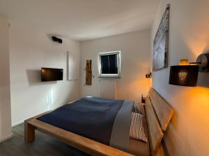 a bedroom with a bed in a room with lights at Inselbutze Fehmarn in Fehmarn