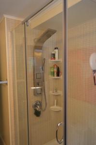 W łazience znajduje się prysznic ze szklanymi drzwiami. w obiekcie Lakeside Cottage w mieście Wentworth