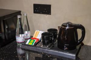 a counter with two bottles of wine and two cups at Ceylon Canopy in Hiriketiya
