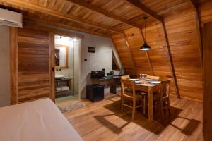a room with a table and chairs and a kitchen at Ceylon Canopy in Hiriketiya +19 photos