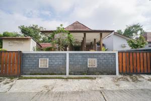 a brick fence in front of a house at Villa Maurine Prambanan in Jogonalan
