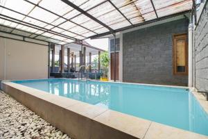 an indoor swimming pool with a brick building at Villa Maurine Prambanan in Jogonalan