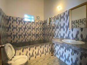a bathroom with a toilet and a sink at The Coconut House Hotel in Battambang +29 photos