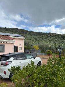a white car parked in front of a house at la Tana di Luna in Adrano