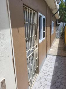 an entrance to a building with a metal gate at Enchanted Guest House & Hostel in Ocho Rios