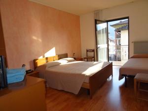 Postel nebo postele na pokoji v ubytování Hotel Galles