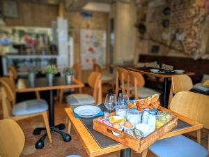 a table with a tray of food and drinks on it at Entre Terre Et Mer in Honfleur