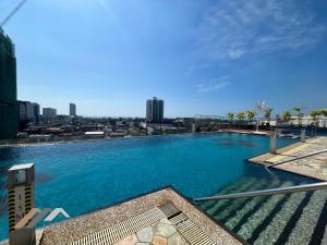 a large swimming pool with a view of the city at Evernent Meritz in Miri