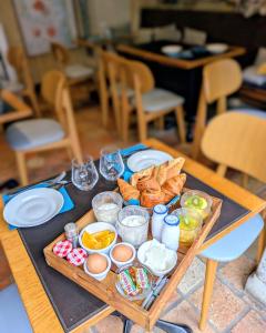 a tray of food on a table with bread and pastries at Entre Terre Et Mer in Honfleur