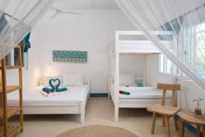 a room with two beds and a ladder at New Teddy's on the Beach in Jambiani +153 photos