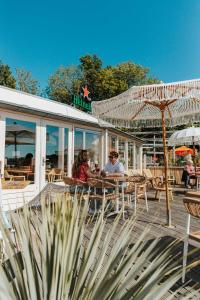 two people sitting at a table outside of a restaurant at Tiny House in Kropswolde