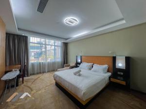 a hotel room with a bed and a large window at Evernent Meritz in Miri +22 photos