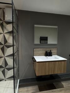 a bathroom with a sink and a mirror at Uno Moor Side - 4 Bed, 2 Bath, Garden, sleeps 8 - Parking in Carbis Bay +24 photos
