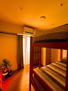 a bedroom with two bunk beds in a room at Haus by Juju in Manila