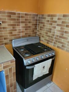 a kitchen with a stove in a kitchen at Enchanted Guest House & Hostel in Ocho Rios
