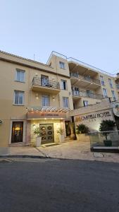 a large building with a sign in front of it at Castelli Hotel Nicosia in Nicosia