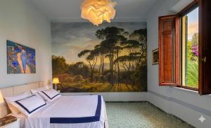 a bedroom with a painting on the wall and a bed at Villa Leonardo House Pisa Secret Garden in Pisa