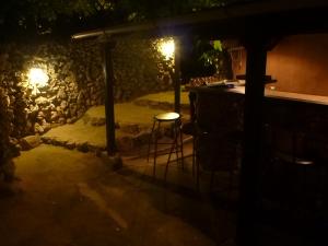 a bar at night with a table and chairs at Taketomijima Akaneya in Taketomi