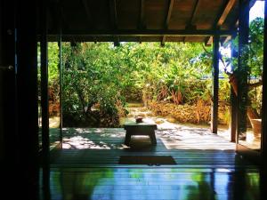 a bench sitting in the middle of a porch at Taketomijima Akaneya in Taketomi