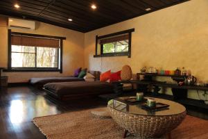 a living room with a couch and a table at Taketomijima Akaneya in Taketomi