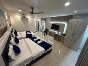 a bedroom with a large bed and a bathroom at Hotel Crown in Dwarka