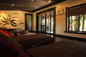 a bedroom with two beds in a room with a window at Taketomijima Akaneya in Taketomi