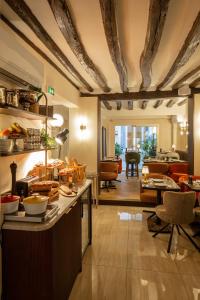 a kitchen with a counter and a living room at Hotel Des Deux Continents in Paris