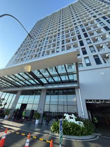 a tall building with orange cones in front of it at Delft Apartement in Tanjungbunga
