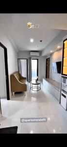a living room with a couch and a table at Delft Apartement in Tanjungbunga