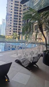 a glass sculpture sitting on a patio next to a palm tree at Knightsbridge Residences with Free Pool, Sauna, Fast WiFi, Gym and Kitchen in Manila