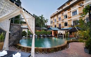 a swimming pool in front of a building at Central Indochine d'Angkor Hotel in Siem Reap