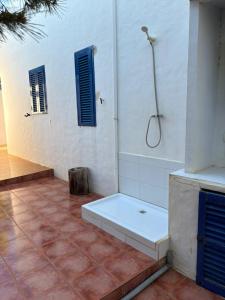 a bathroom with a shower with a bench in it at Casa Carpe Diem in Es Arenals