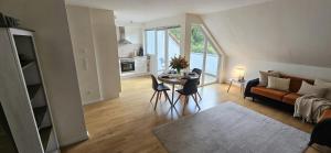 a living room with a table and a couch at Pferdeparadies Untergrünhagen in Bad Fallingbostel