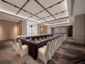 a large conference room with a long table and white chairs at Four Points by Sheraton Qingtian in Qingtian